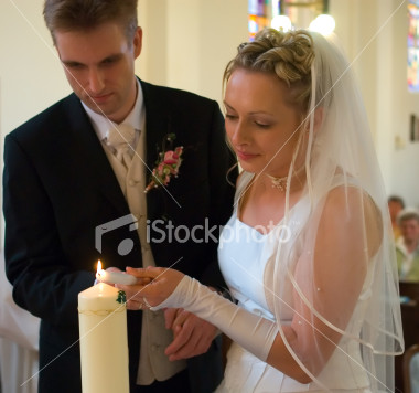 ist2_2326776-bride-and-groom-lighting-candle1